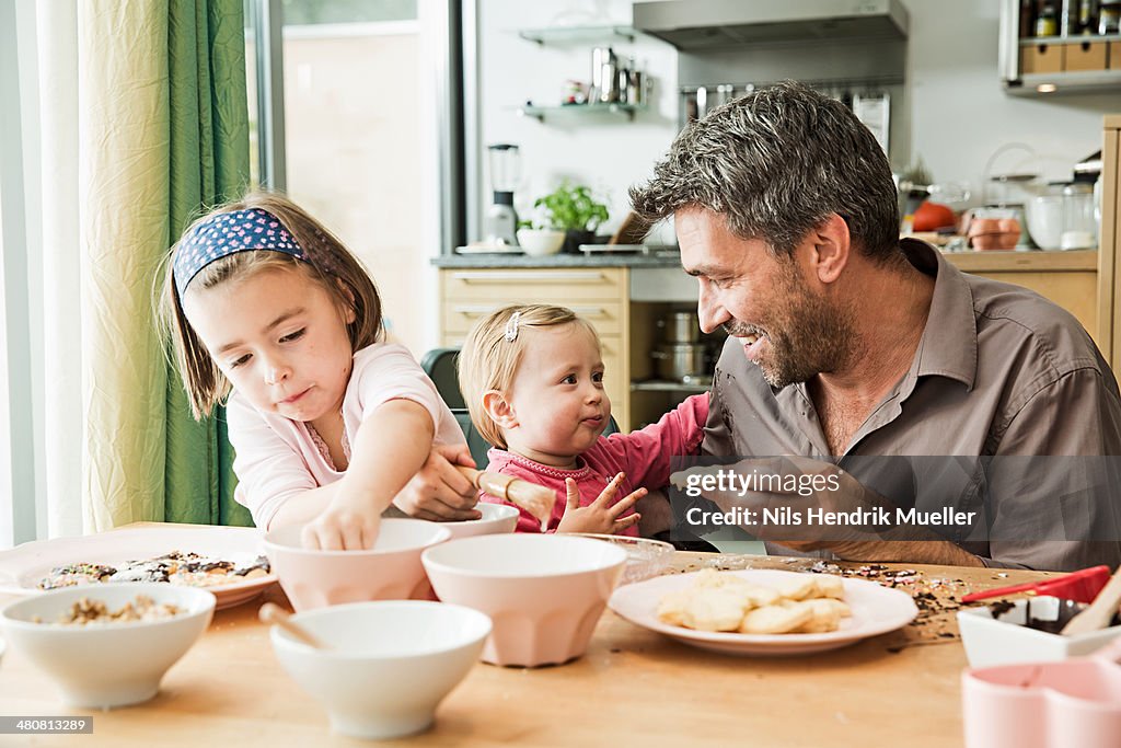 Father and children baking in kitchen