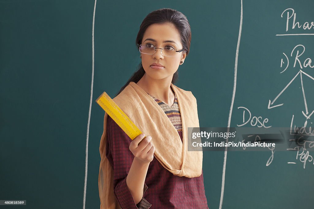 Reference Photo Angry Teacher Ruler Angry Young Female Teacher Holding Ruler Against Chalkboard High-Res ...
