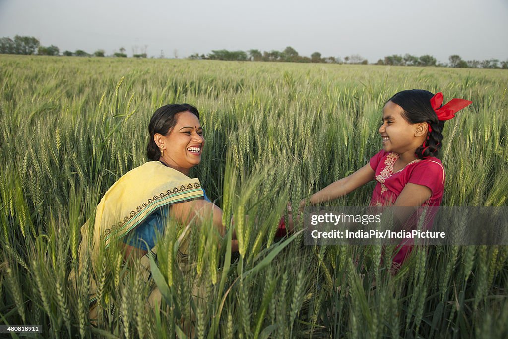 Mother and daughter laughing in farm