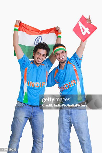 portrait of happy male cricket fans in jerseys cheering over white background - cricket jersey stock pictures, royalty-free photos & images