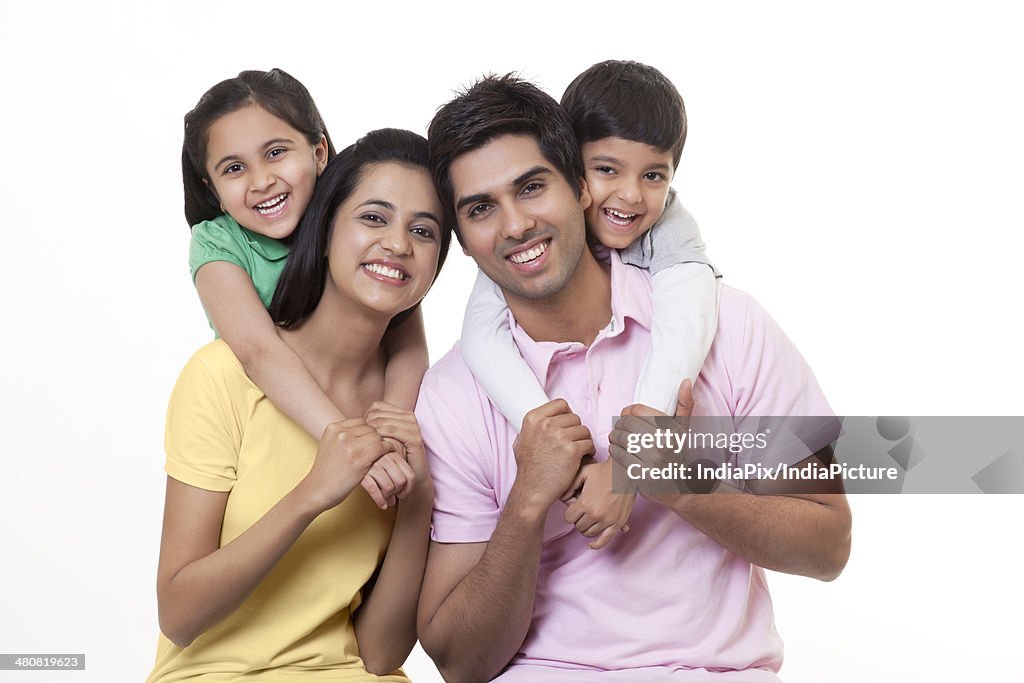 Portrait of a Indian family smiling over white background