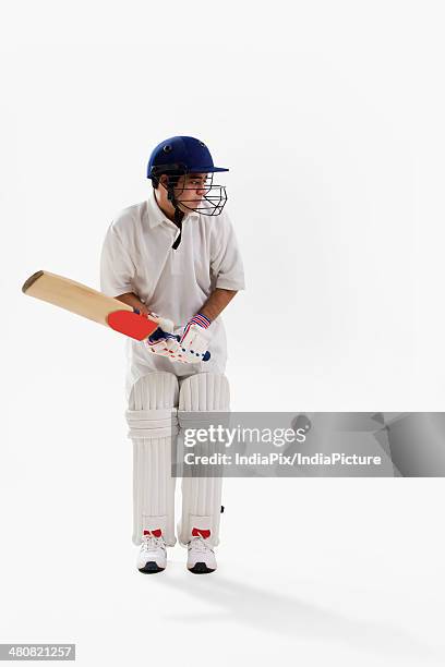 full length of young man playing cricket over white background - cricket player isolated stock pictures, royalty-free photos & images