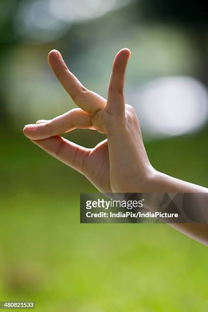 close-up of woman's hand in yoga gesture - mudra stock pictures, royalty-free photos & images