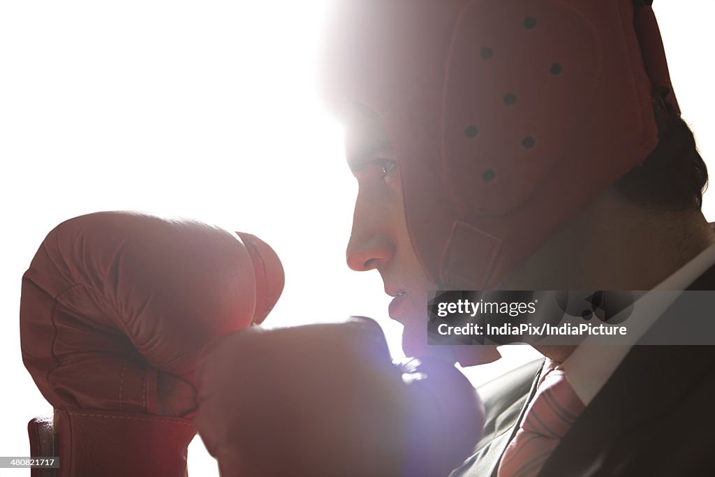 Businessman with boxing gloves in boxing stance