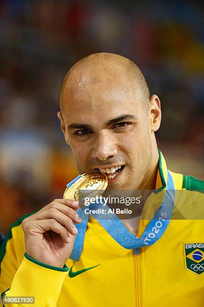 Joao De Lucca of Brazil stands with the gold medal after winning the Mens 200m Freestyle finals at the Pan Am Games on July 15, 2015 in Toronto,...