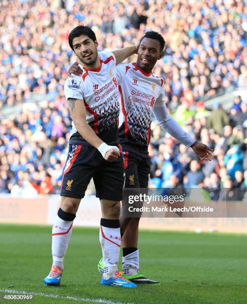 Daniel Sturridge of Liverpool celebrates with teammate Luis Suarez after scoring their 5th goal during the Barclays Premier League match between...