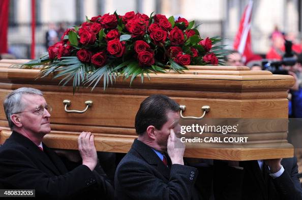 Pallbearers including son Hilary Benn carry the coffin containing the ...