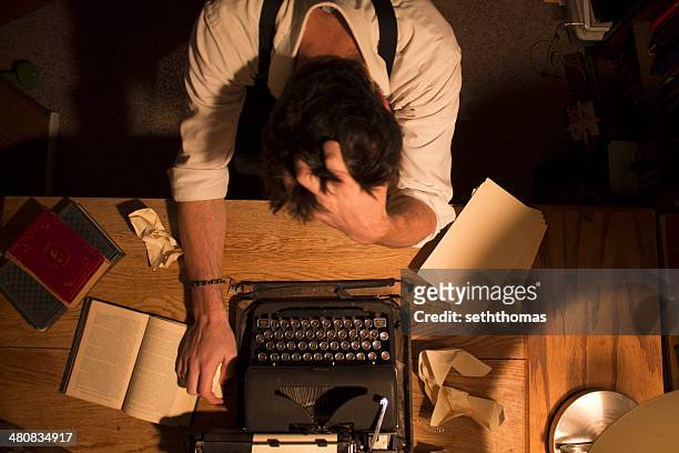 man sitting at desk with writers block - author stock pictures, royalty-free photos & images