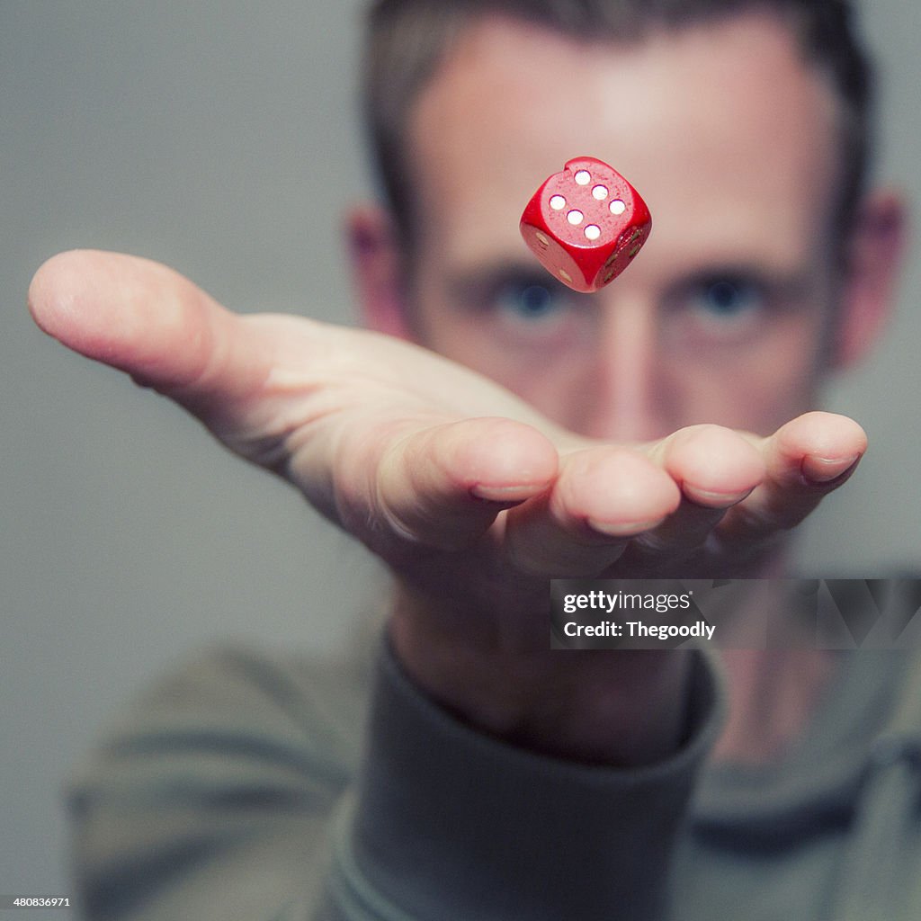 Man throwing dice in air