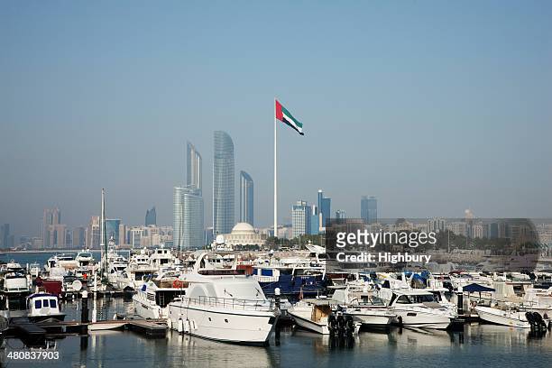 united arab emirates, abu dhabi, skyline with harbor in foreground - the united arab emirates flag stock pictures, royalty-free photos & images