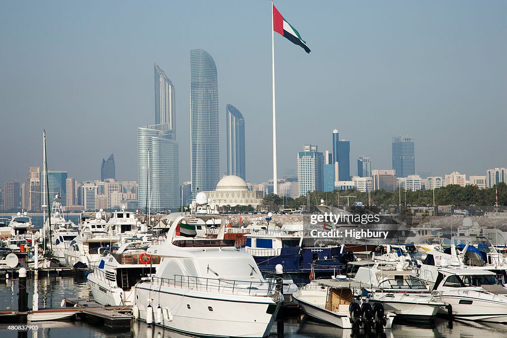 United Arab Emirates, Abu Dhabi, Skyline with harbor and boats in foreground