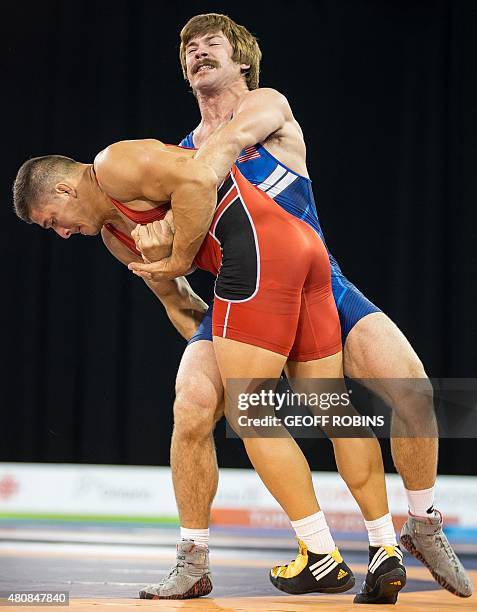Andrew Bisek of the United States throws Alvis Almendra of Panama during the gold medal bout in the 75kg class of the men's greco-roman wrestling at...