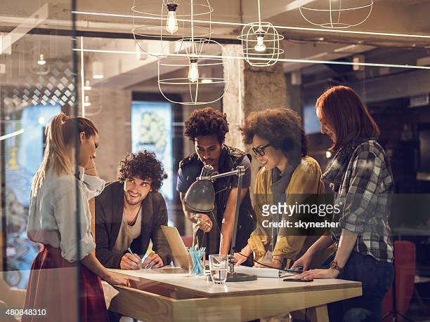 team of young designers having a meeting in the office. - creative occupation stock pictures, royalty-free photos & images