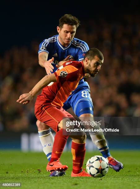 Frank Lampard of Chelsea tangles with Yekta Kurtulus of Galatasaray during the UEFA Champions League Round of 16 2nd leg match between Chelsea and...