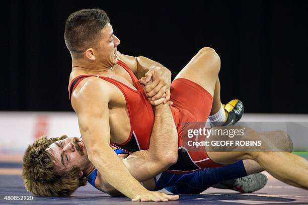 Andrew Bisek of the United States rolls Alvis Almendra of Panama during the gold medal bout in the 75kg class of the men's greco-roman wrestling at...