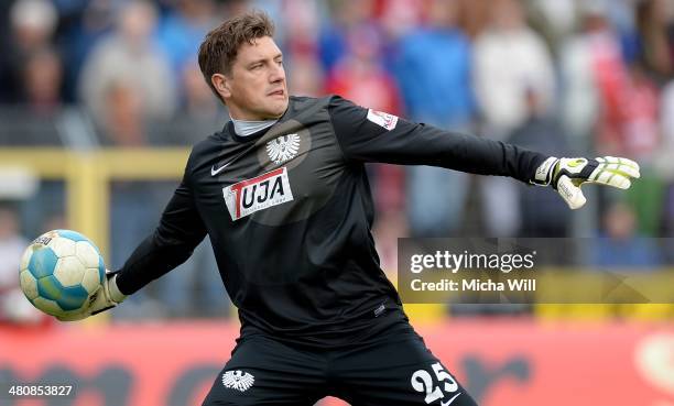 Goalkeeper Daniel Masuch of Muenster throws the ball during the Third League match between Jahn Regensburg and Preussen Muenster at Jahnstadion on...