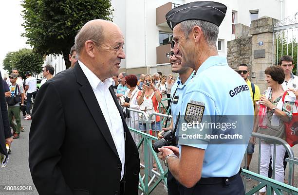 French Minister of Defence Jean-Yves Le Drian attends stage nine of the 2015 Tour de France, a 28 km team time trial from Vannes to Plumelec on July...