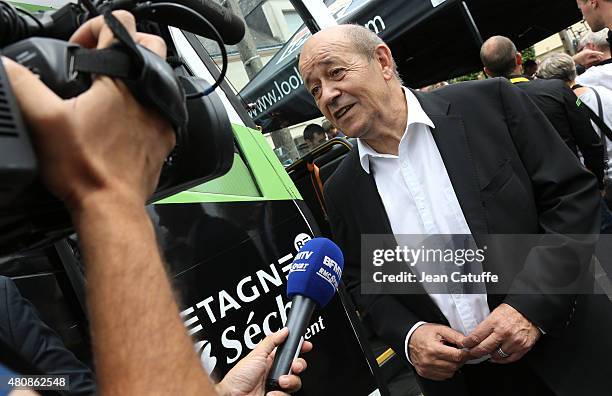 French Minister of Defence Jean-Yves Le Drian attends stage nine of the 2015 Tour de France, a 28 km team time trial from Vannes to Plumelec on July...