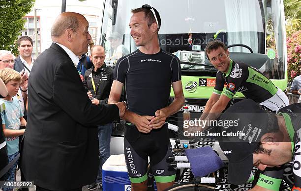 French Minister of Defence Jean-Yves Le Drian greets the riders of Team Bretagne Seche Environnement during stage nine of the 2015 Tour de France, a...