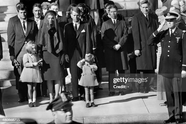 Jacqueline Kennedy stands with her two children Caroline Kennedy and John F. Kennedy Jr and brothers-in law Ted Kennedy and Robert Kennedy at the...