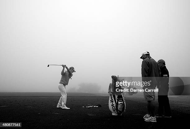 Billy Horschel practices on the range during a rain delay during Round One of the Valero Texas Open at the AT&T Oaks Course on March 27, 2014 in San...
