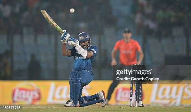 Tillakaratne Dilshan of Sri Lanka scoops the ball during the ICC World Twenty20 Bangladesh 2014 Group 1 match between England and Sri Lanka at Zahur...