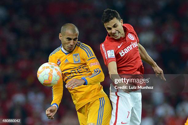 Nilmar of Internacional jumps for the ball with Guido Pizarro of Tigres during a Semi Final match between Internacional and Tigres as part of Copa...