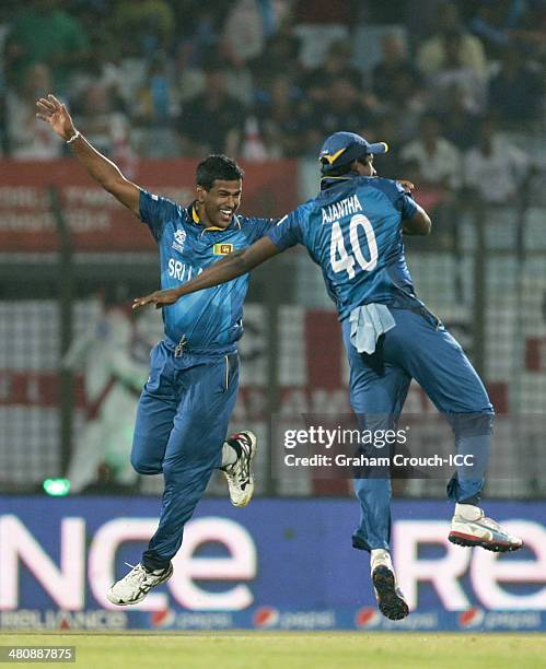 Nuwan Kulasekara of Sri Lanka celebrates with Ajantha Mendis the wicket of Moeen Ali of England during the England v Sri Lanka match at the ICC World...