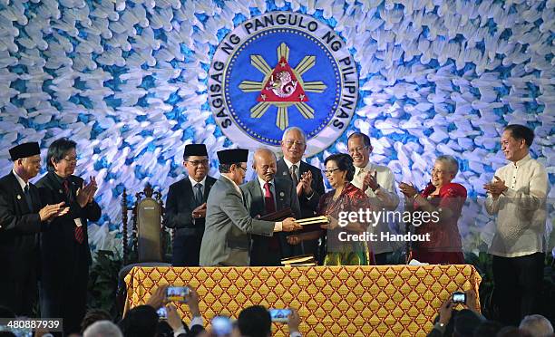 In this handout from the Presidential Photo Division, President Benigno S. Aquino III and Malaysian Prime Minister Dato' Sri Haji Mohammad Najib bin...