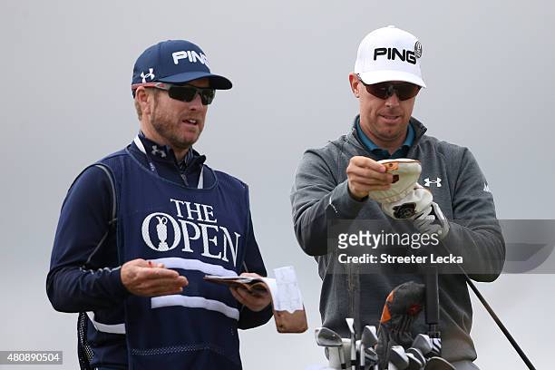Hunter Mahan of the United States with caddie John Wood as he tees off on the 6th hole during the first round of the 144th Open Championship at The...