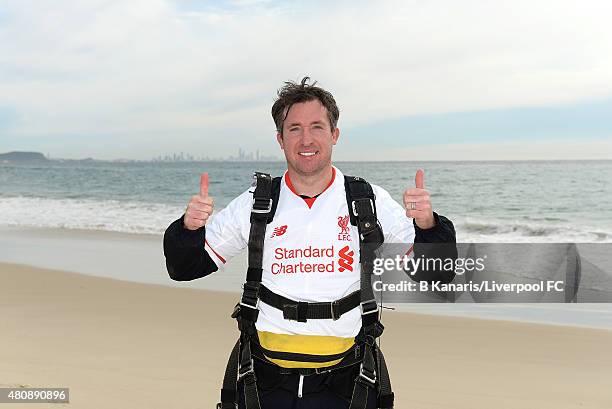 Robbie Fowler holds up the new Liverpool away jersey after sky diving onto Kirra Beach on July 16, 2015 at the Gold Coast, Australia.