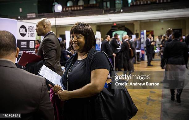 Private First Class Latasha Peeler, of the United States Army, meets with a recruiter at a 'Hiring our Heroes' Job Fair on March 27, 2014 in New York...