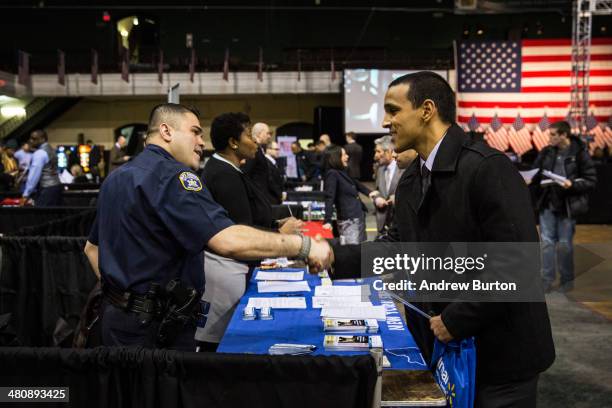 Sergeant Jesus Adames , of the United States Army National Guard, meets with a recruiter at a 'Hiring our Heroes' Job Fair on March 27, 2014 in New...