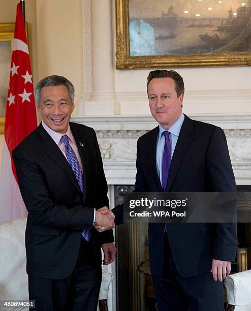 Singapore's Prime Minister Lee Hsien Loong shakes hands with British Prime Minister David Cameron before the start of their meeting inside 10 Downing...