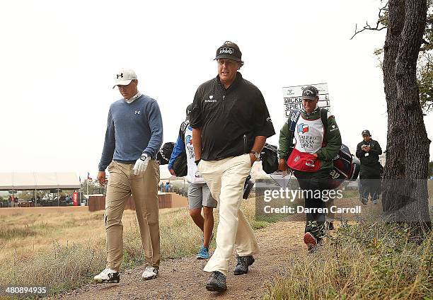 Phil Mickelson and Jordan Spieth walk from the 11th tee during Round One of the Valero Texas Open at the AT&T Oaks Course on March 27, 2014 in San...