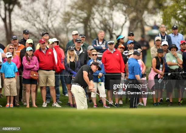 Phil Phil Mickelson plays a shot on the 13th during Round One of the Valero Texas Open at the AT&T Oaks Course on March 27, 2014 in San Antonio,...