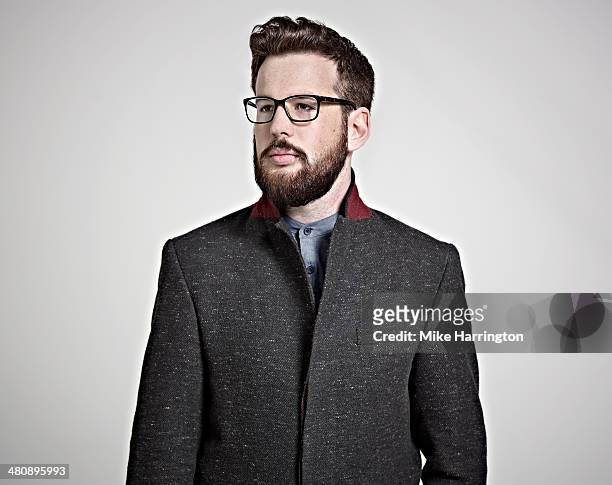 bearded man in coat and glasses looking sideways. - overcoat stock pictures, royalty-free photos & images