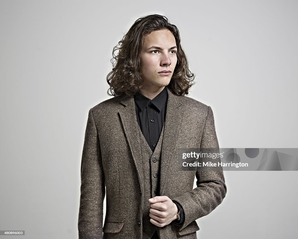 Portrait of young man in brown suit.