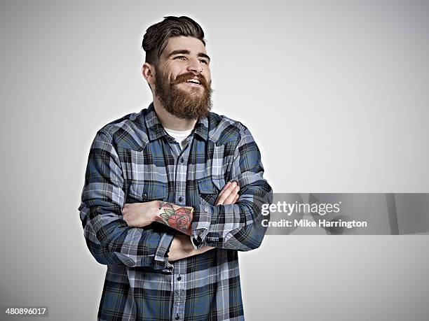 portrait of male in check shirt laughing. - plaid shirt stock-fotos und bilder