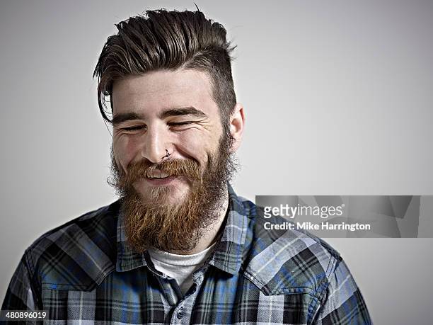 portrait of bearded man smiling with eyes closed. - hipster stock-fotos und bilder