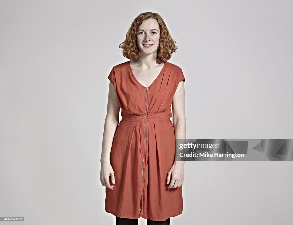 Portrait of woman with red hair smiling to camera.