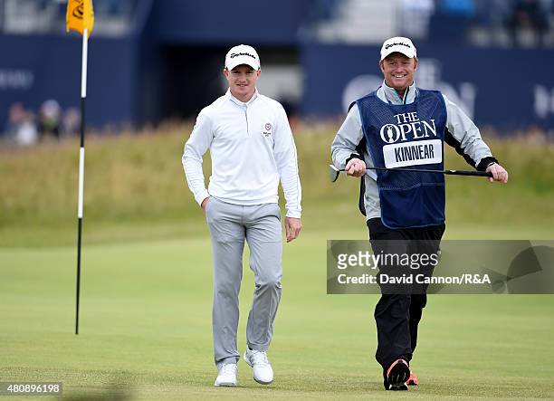 Amateur Paul Kinnear of England reacts after making a putt for birdie on the first green during the first round of the 144th Open Championship at The...