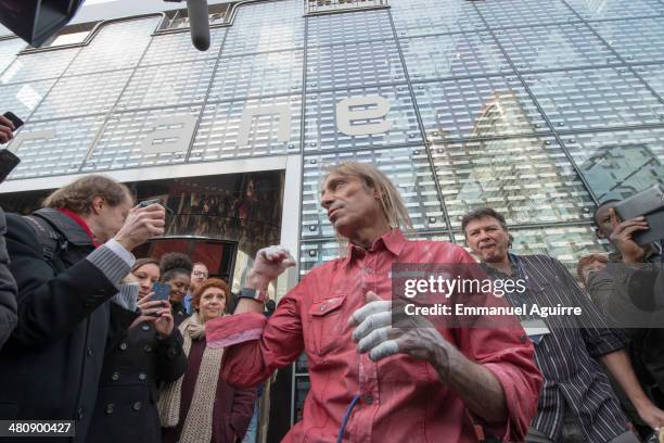 Alain Robert is interviewed by media after climbing the Ariane Tower, situated in the La Defense business centre on March 27, 2014 in Paris, France....