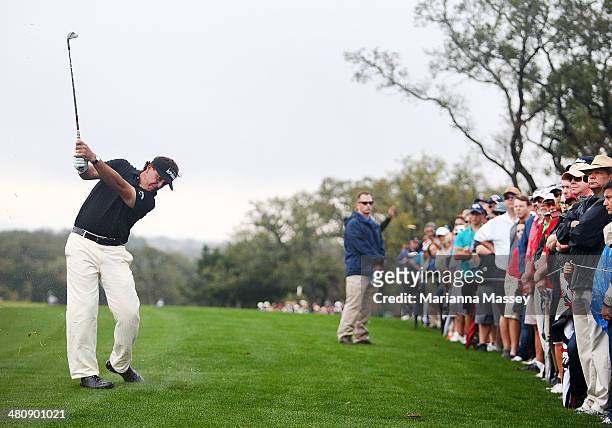 Phil Mickelson plays a shot on the 12th during Round One of the Valero Texas Open at the AT&T Oaks Course on March 27, 2014 in San Antonio, Texas.