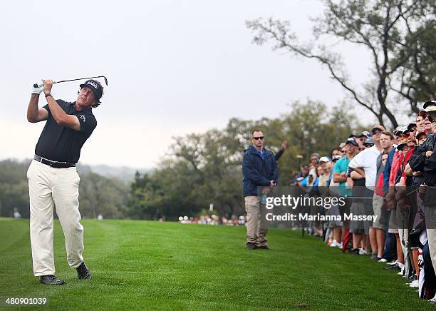 Phil Mickelson plays a shot on the 12th during Round One of the Valero Texas Open at the AT&T Oaks Course on March 27, 2014 in San Antonio, Texas.