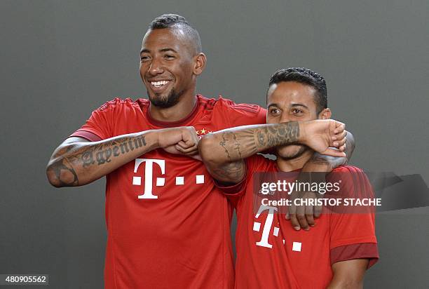 Bayern Munich's defender Jerome Boateng and Bayern Munich's Spanish midfielder Thiago Alcantara joke during a team photo of German first division...