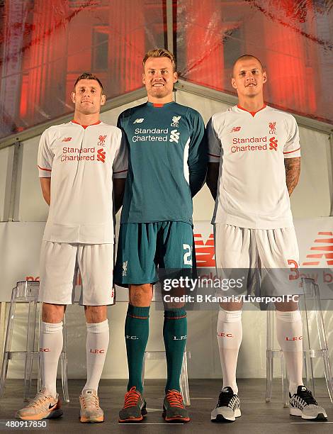 Liverpool players James Milner, Simon Mignolet and Martin Skrtel show off the new away playing kit at the official away jersey launch at King George...