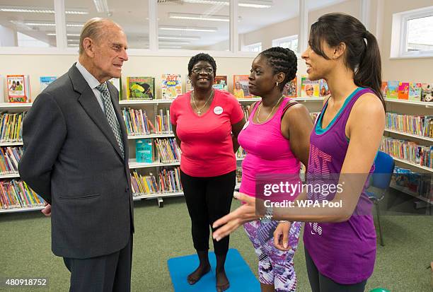 Prince Philip, Duke of Edinburgh speak to participants of a pilates class during a visit to Chadwell Heath Community Centre on July 16, 2015 in...