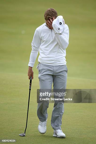 Amateur Paul Kinnear of England reacts on the 18th green during the first round of the 144th Open Championship at The Old Course on July 16, 2015 in...