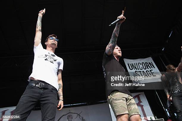 Singer Kyle Pavone and singer Dave Stephens of We Came as Romans performs at PNC Music Pavilion on July 7, 2015 in Charlotte, North Carolina.